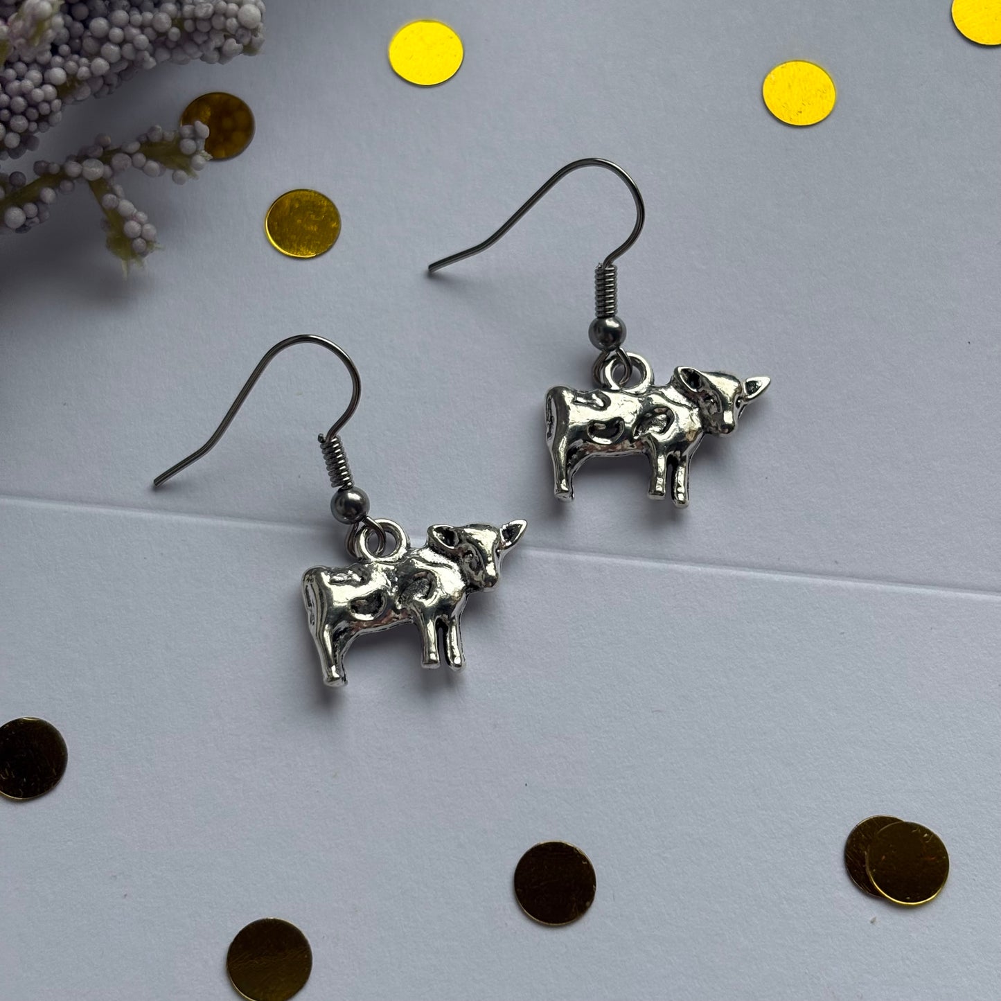 Silver cow earrings on hypoallergenic hooks