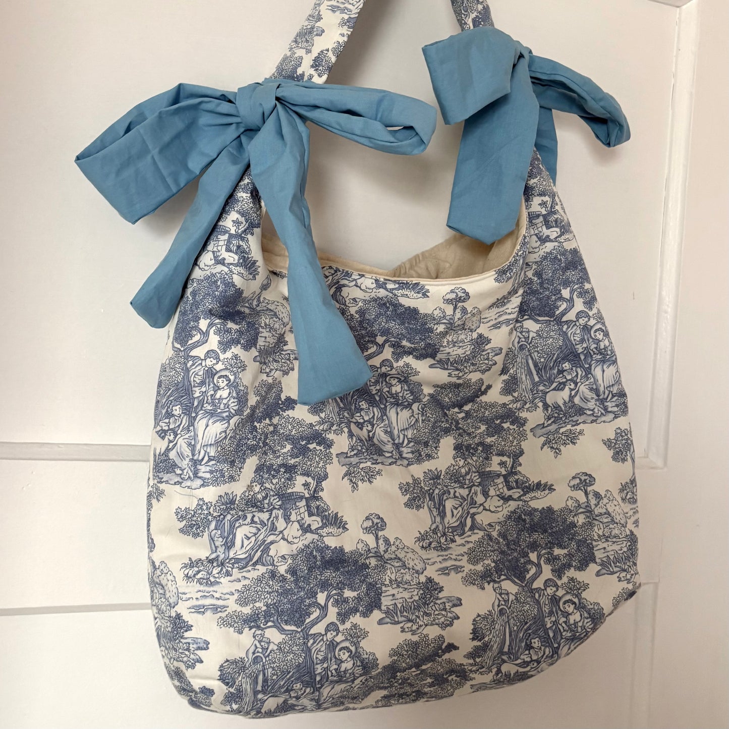 Handmade white and blue porcelain coquette farm print padded tote bag with blue bows