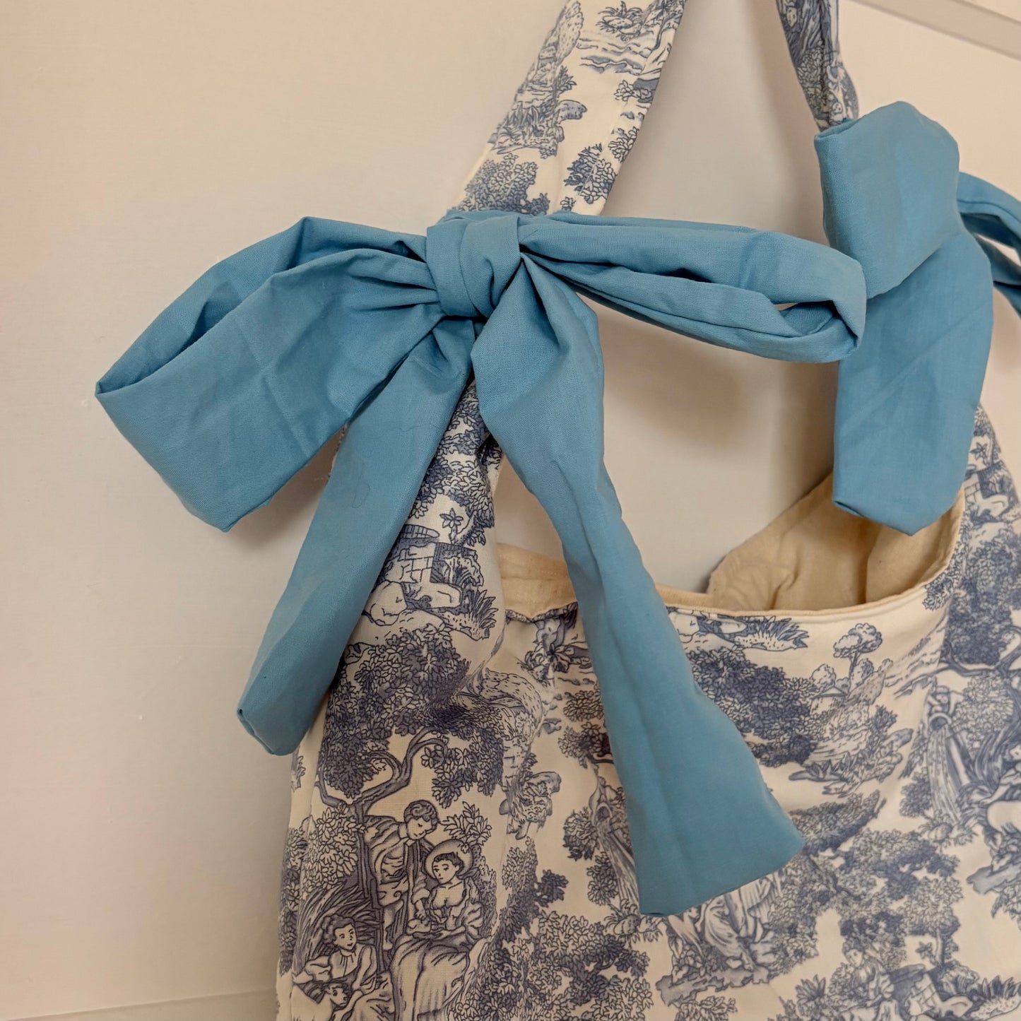 Handmade white and blue porcelain coquette farm print padded tote bag with blue bows
