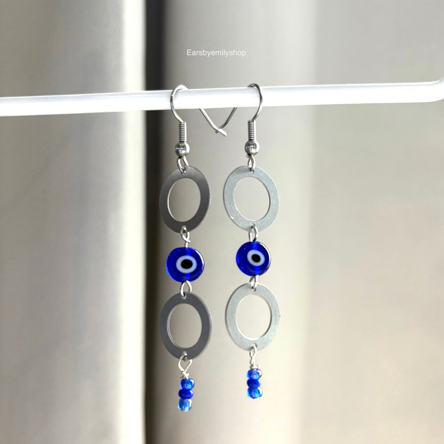 Stainless steel circle and blue evil eye bead statement dangle earrings
