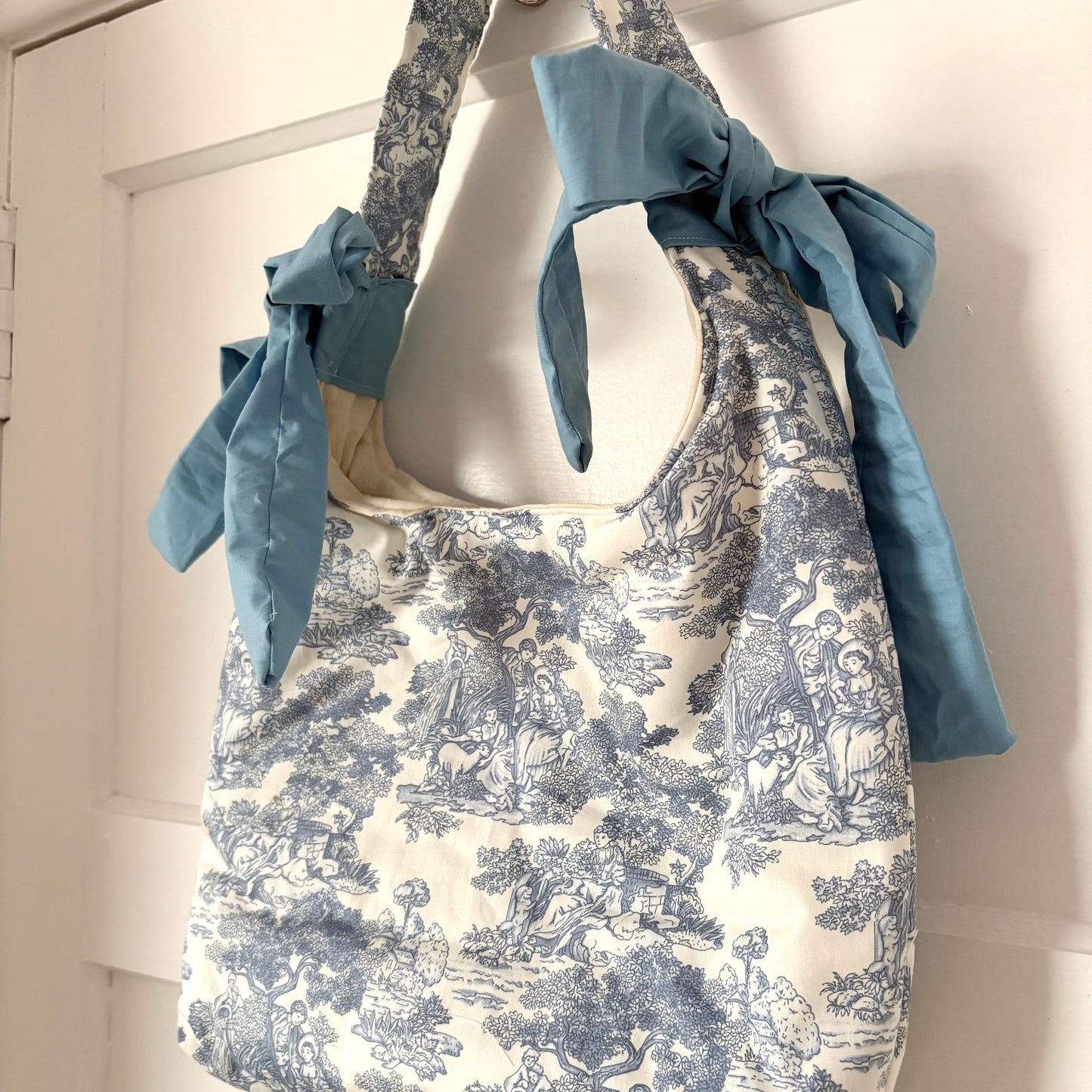 Handmade white and blue porcelain coquette farm print padded tote bag with blue bows