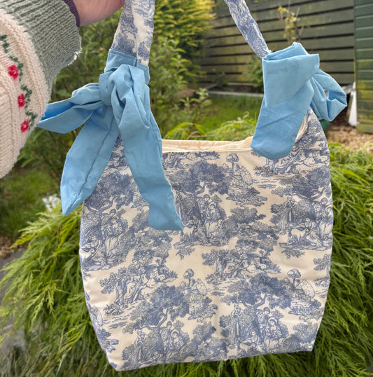 Handmade white and blue porcelain coquette farm print padded tote bag with blue bows