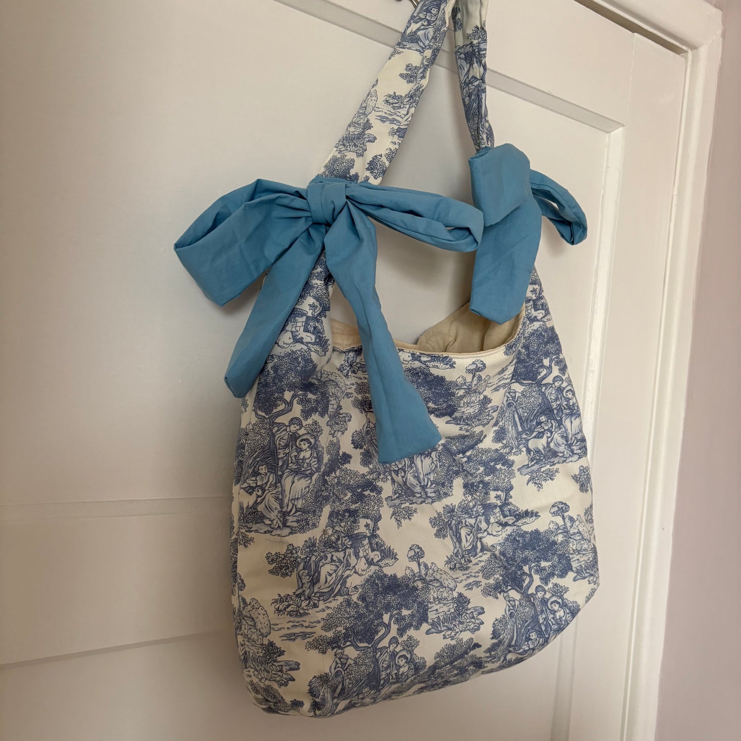 Handmade white and blue porcelain coquette farm print padded tote bag with blue bows