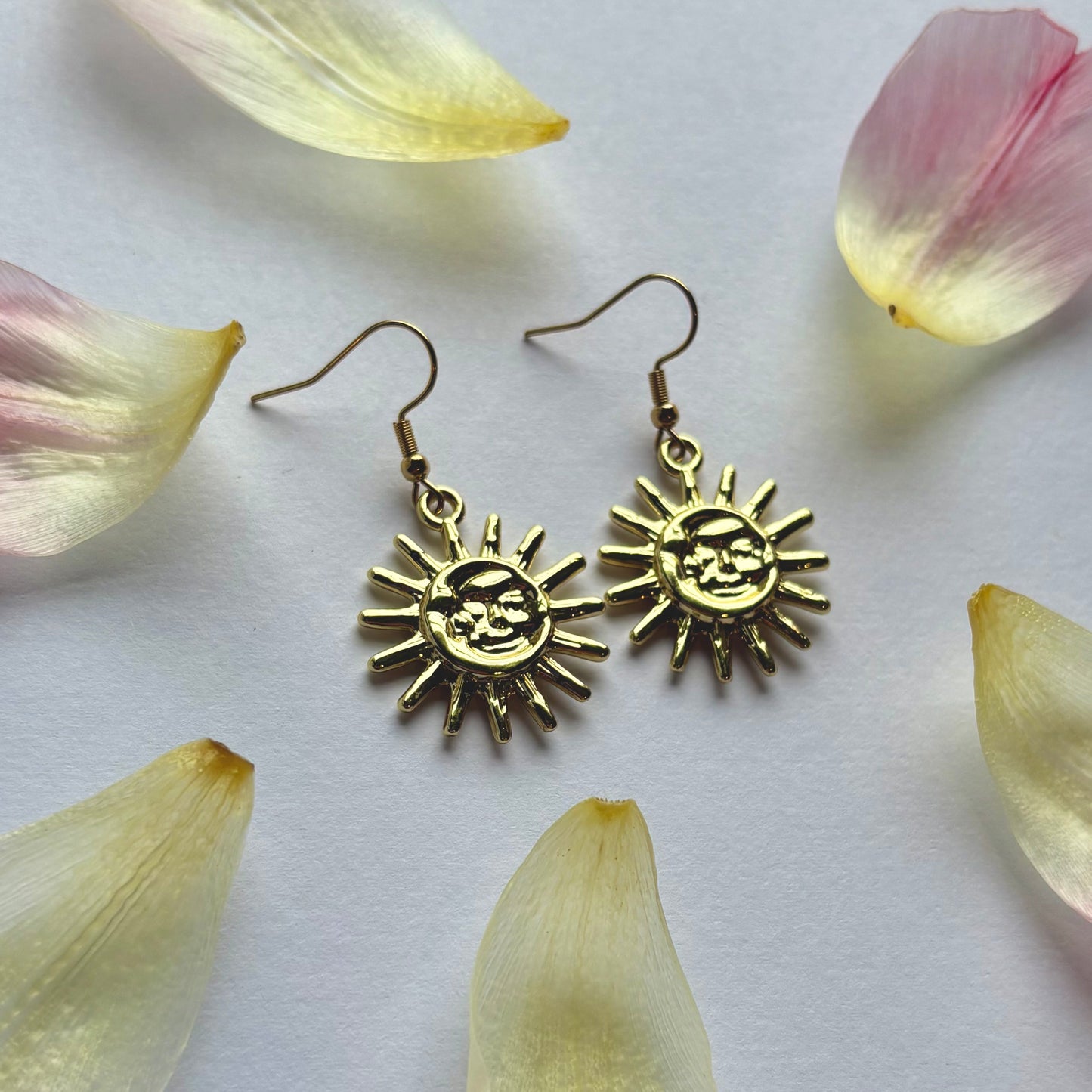 Cool quirky gold sun and moon face celestial dangle earrings