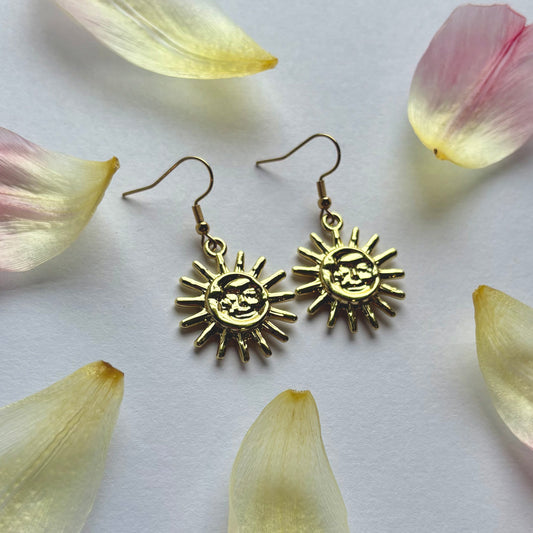 Cool quirky gold sun and moon face celestial dangle earrings